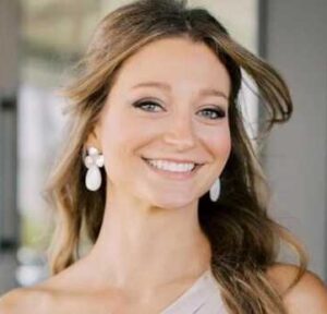 white woman with brown hair smiling at camera