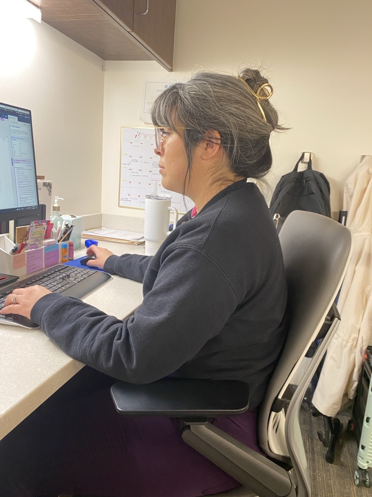 Marissa Salinas sitting in front of a computer at a work desk